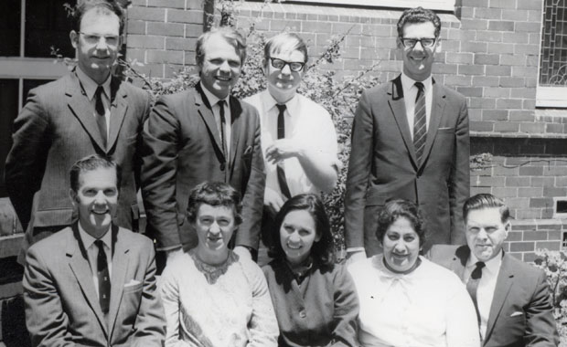 The nine members of the Australian National Spiritual Assembly for 1969 are facing the camera.